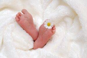 newborn-baby-doctor-soft-foot-of-newborn-baby-with-flower