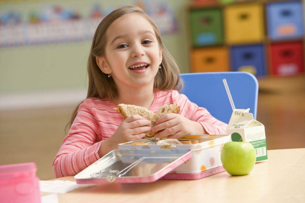 happy kid with nutritious lunches