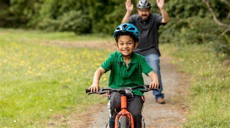 child happy ride a bike