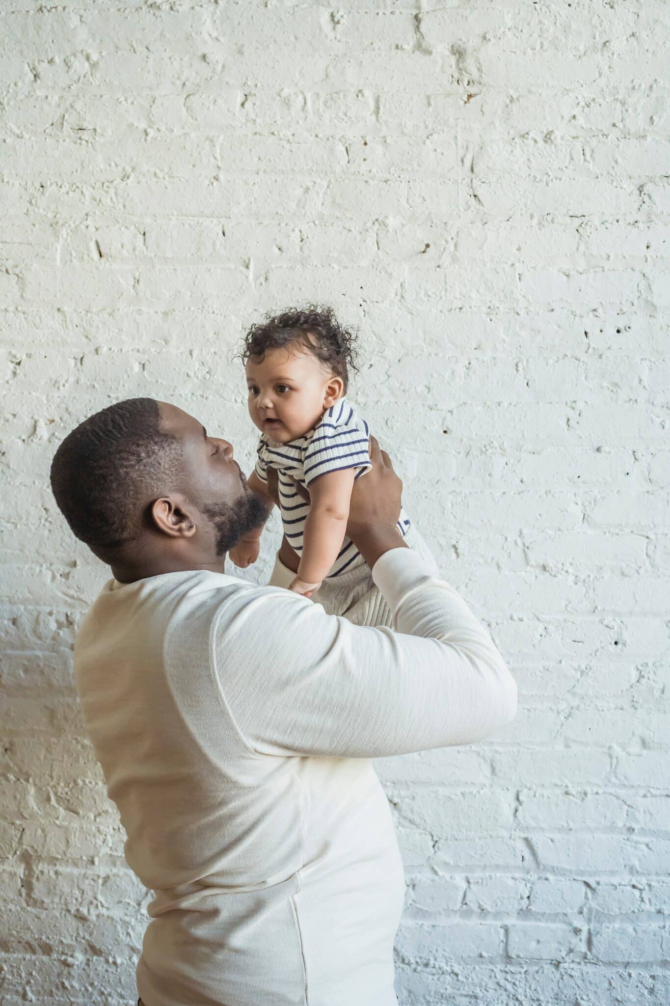 pediatrician for babies father carrying his lovely baby scaled