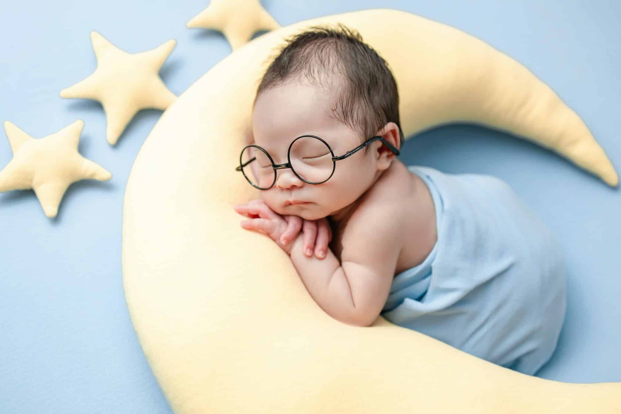 charming newborn baby wearing eye glass