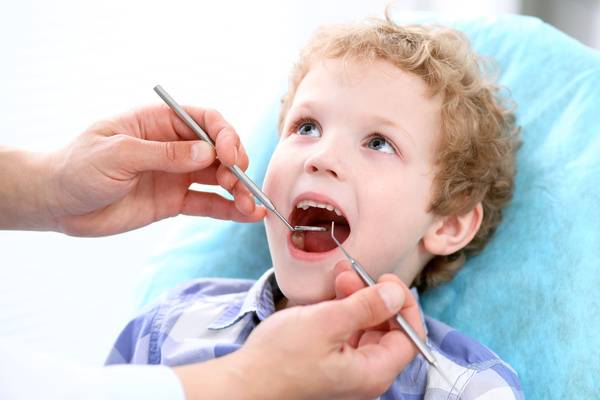 tooth-Close up of boy having his teeth examined by a dentist for gingivitis-dental health-Dental Insurance