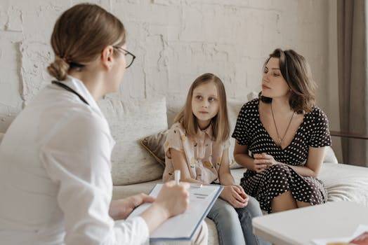 pexels-photo-7653094-7653094 A mother and daughter consult with a doctor during a medical appointment indoors.